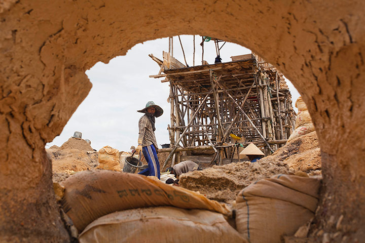 Tin Mining: Miners working at a PT Timah tin ore mine in Tanjung Pesona