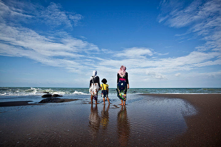 Tin Mining: Visitors enjoying the view at Tanjung Pesona beach in Tanjung Pesona