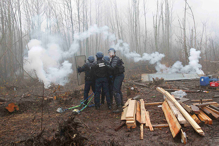 24 hours: Riot gendarmes huddle together during an evacuation