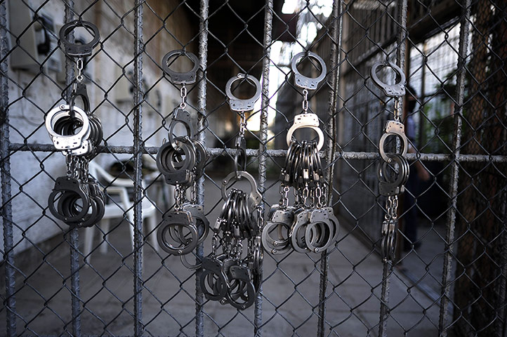 24 hours: Handcuffs hang from a wire netting at La Esperaza Jail in San Salvador
