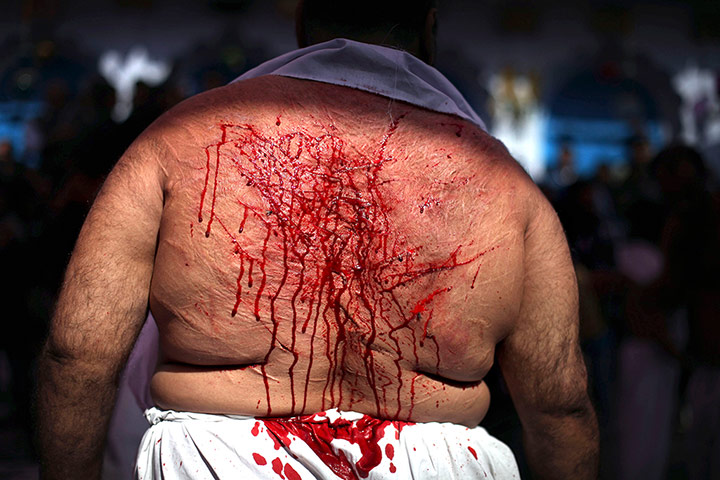 24 hours: A Shiite Muslim stands with a bleeding back to mark Muharram