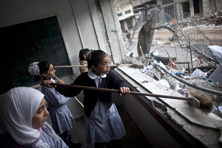 24 hours: Gaza City, Gaza Strip: Palestinian girls clean debris from their classroom