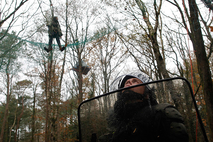 24 hours: Notre-Dame-des-Landes, France: A riot police officer secures the area