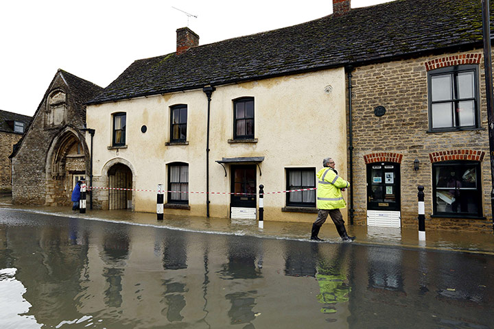 UK flooding: An emergency services worker cordons off houses in Malmesbury