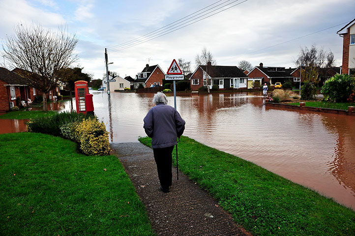 UK flooding: An elderly woman comes to the end of the footpath in Somerset