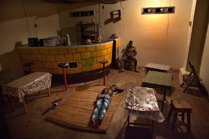 FTA: Joe Penney: A man sleeps on the floor of a bar, Bolama