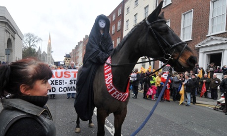 A protestor rides on a horse draped in a sash bearing the slogan "No To Austerity" at the head of a march against Government austerity measures in Dublin, Ireland 