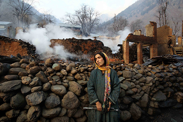 24 hours: Pahalgam, India: Villagers look at the debris after a fire