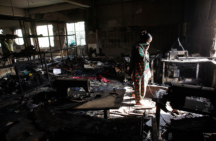 24 hours: Savar, Bangladesh: A worker visits a burnt garment factory