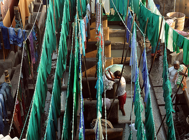 24 hours: Mumbai, India: Washers at the Mahalaxmi Dhobi Ghat (washing place) 