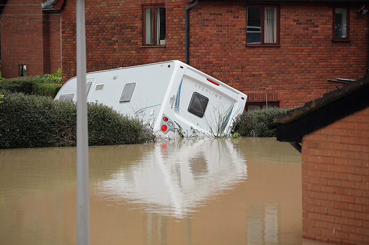 Residents rescued floods:  A camper van turns on its side in St Asaph 