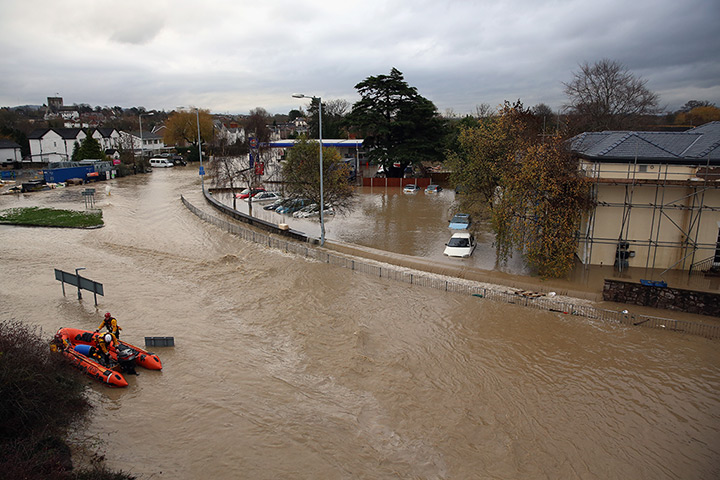 Residents rescued floods: An RNLI life boat crew work in the flooded streets of St Asaph