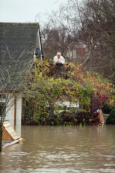 Residents rescued floods: A resident watches floodwaters