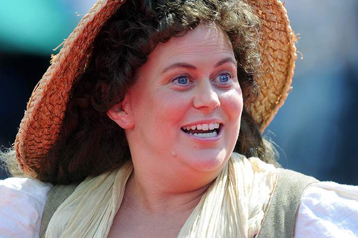 The Hobbit premiere: An actor dressed as Shire folk warms up the crowd on the red carpet