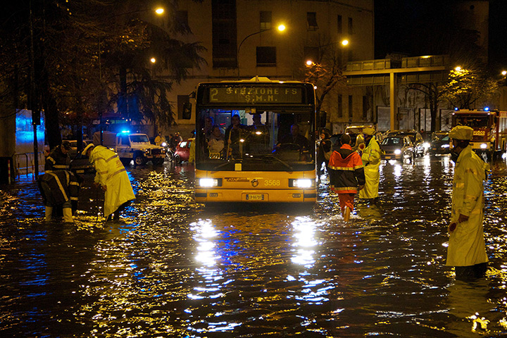 24hours in pictures: Traffic policemen stand in a flooded street late after the Medusa storm
