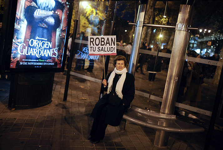24hours in pictures: A woman holds a placard  in Madrid