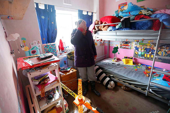 Floods clear-up: Claire Austin reacts as she stands in her children's bedroom in St Asaph