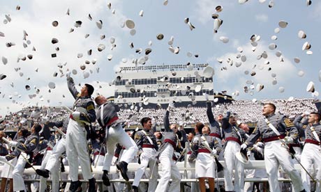 Military cadets throw hats in the air