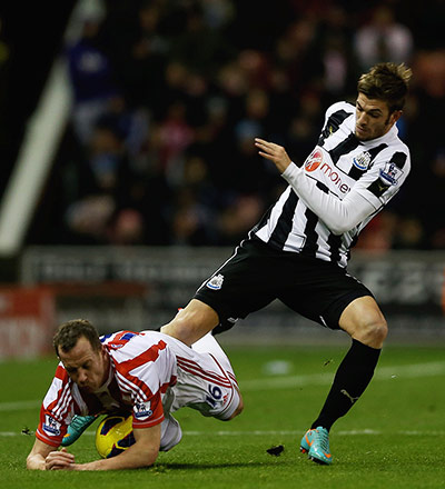 wednesday prem: Stoke's Charlie Adam feels the full force of Davide Santon's challenge