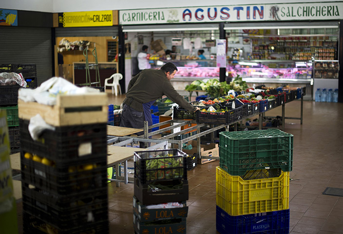 FTA: Jasper Juinen: A market salesman packs up his unsold vegetables on the local market