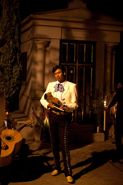 24 hours: A mariachi holds his violin at the Day of the Dead celebrations in San Gregorio, Mexico