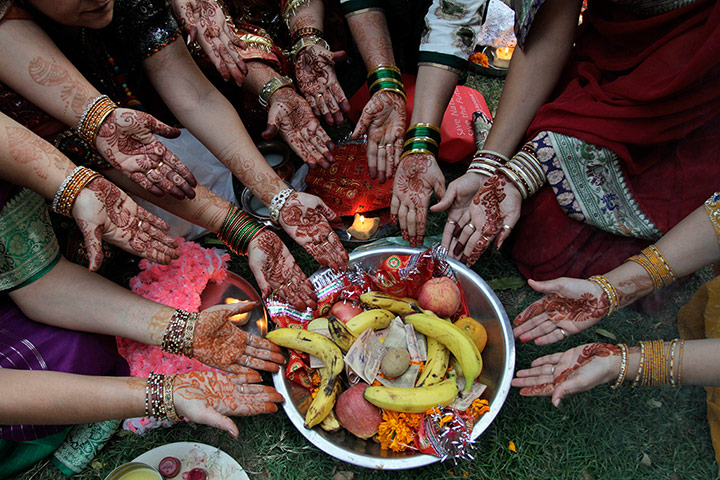 24 hours: Married Hindu women perform rituals on the festival of Karva Chauth in Ahmedabad, India