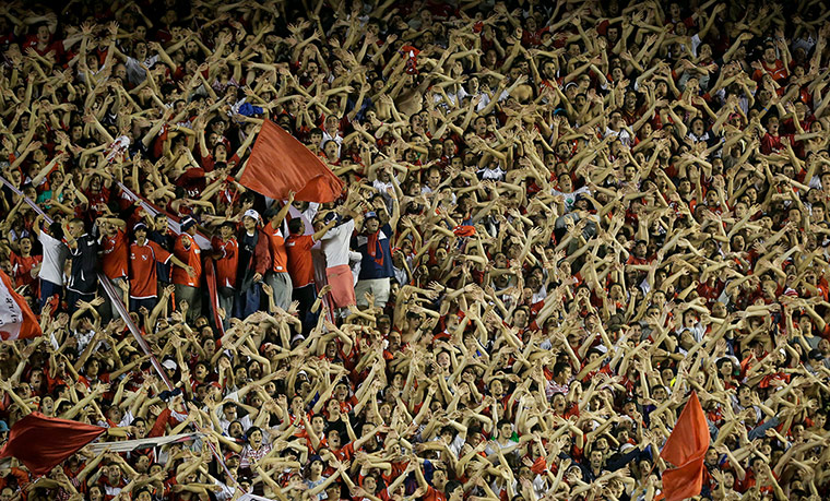 Twenty Photos: Argentina's Independiente fans cheer against Chile's Universidad Catolica