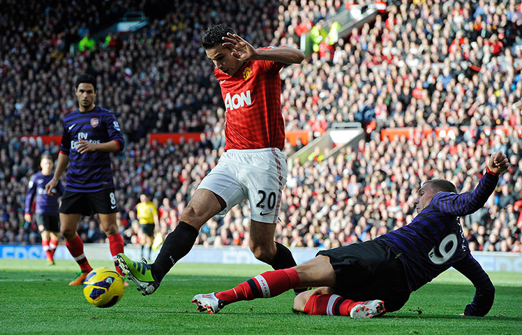 Man Utd v Arsenal: Robin Van Persie skips past a Lukas Podolski challenge