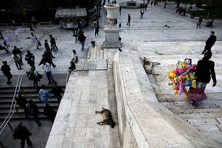 24 hours in pictures: People walk outside a metro station at Syntagma square 