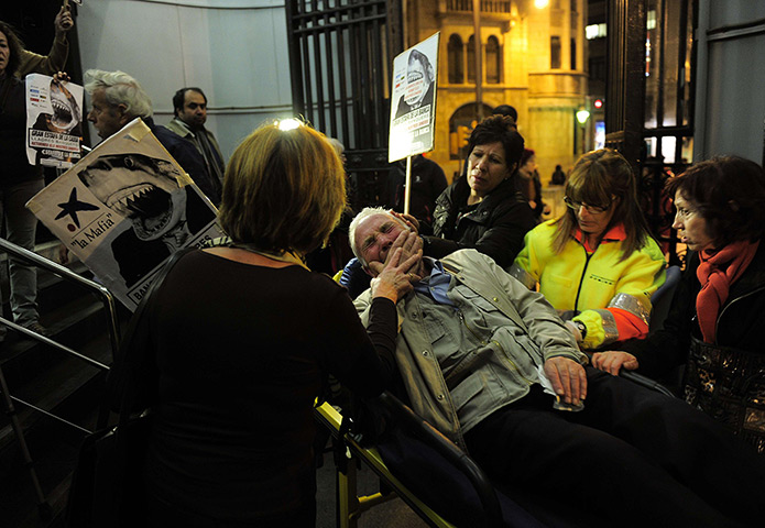 24 hours in pictures: A protester who had an anxiety attack gets medical assistance, Barcelona