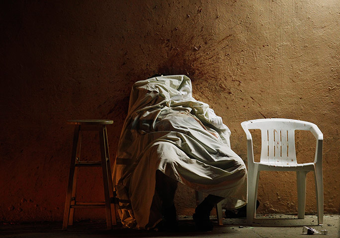 Mexico drug wars gallery: The body of an alleged drug dealer covered by a sheet