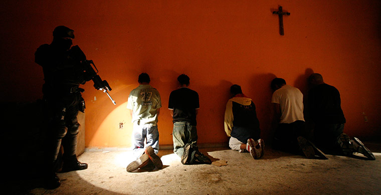 Mexico drug wars gallery: A member of Mexico's AFI stands guard 
