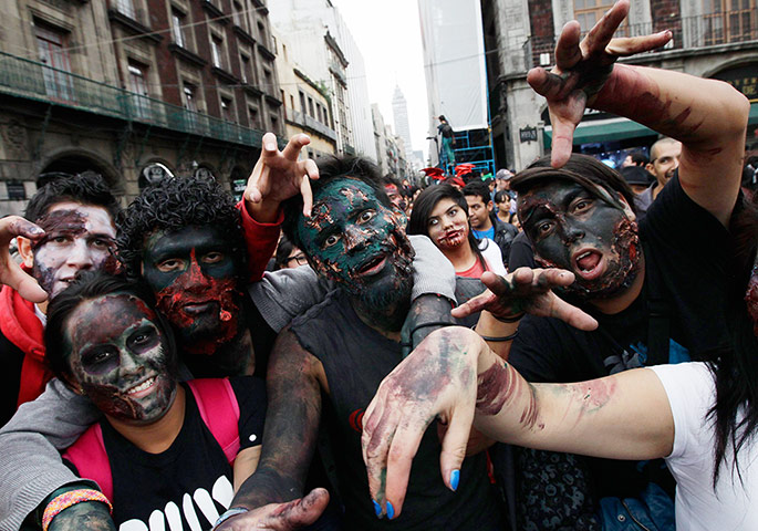 Zombie walk: Zombies gesture towards the camera