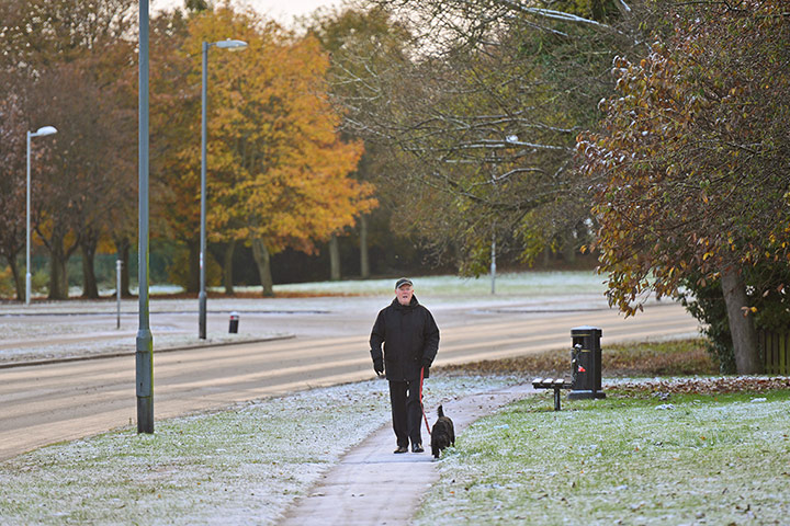 UK weather: Peterlee, County Durham: A dog walker braves the cold weather