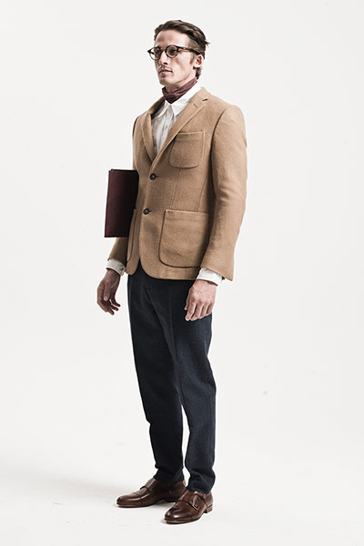 All Ages: Tailoring: Model wears camel jacket with cream shirt and navy trousers