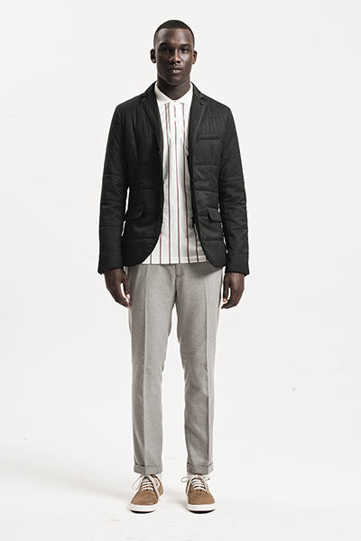 All Ages: Tailoring: Model wears padded black blazer, white polo shirt and light grey trousers