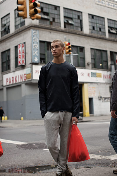 Fashion: H&M in NY: Male model in front of traffic lights on a  New York street