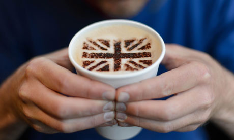 A man poses with a cappuccino with choco