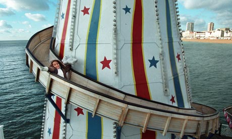A six year old black girl rides down the Helter Skelter on Brighton pier