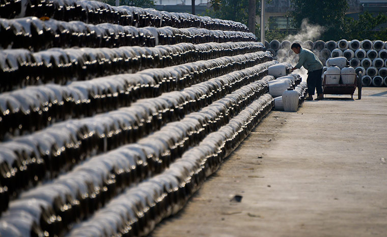 24 hours: Shaoxing, China: A worker prepares crocks used to store yellow rice wine