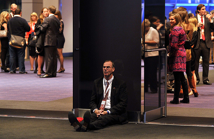 US reaction: A supporter of Mitt Romney sits on the floor on in Boston Massachusetts