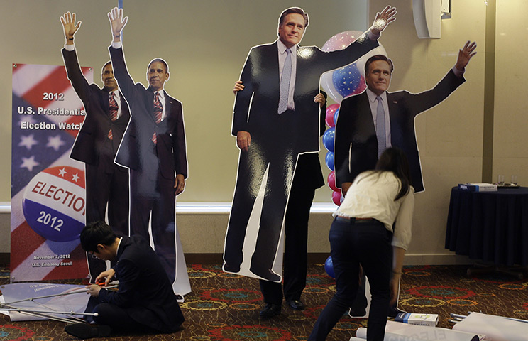 World election reaction: Seoul, South Korea:  A woman carries a cut out of Mitt Romne