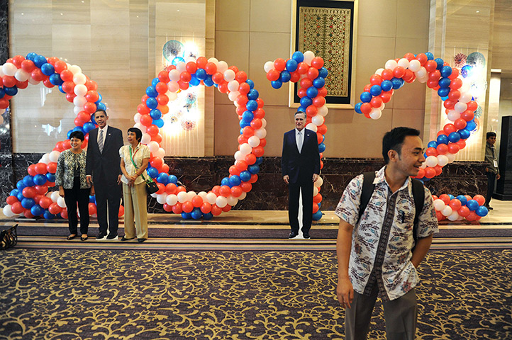 World election reaction: Jakarta, Indonesia: People pose next to the life size Barack Obama