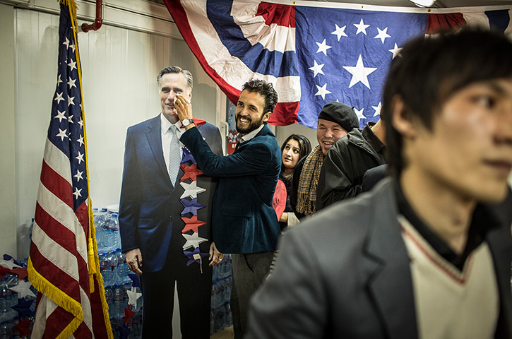 World election reaction: Kabul, Afghanistan: An Afghan journalist gestures with photo of Mitt Romney