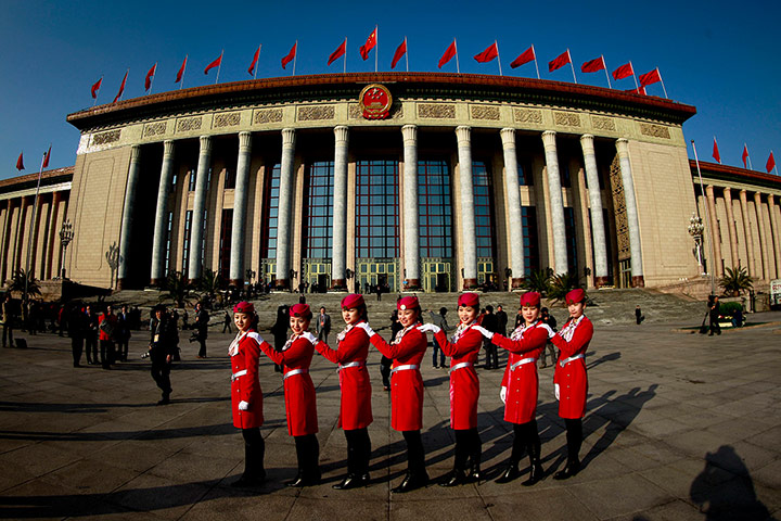 China national congress: Hostesses pose for photographs in front of the Great Hall of the People