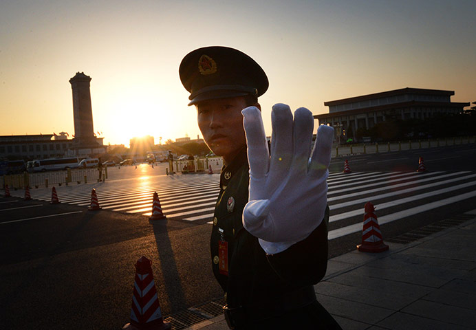 China national congress: A Chinese paramilitary policeman reacts outside the congress