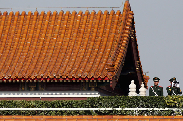 China national congress: Chinese policemen monitor the area with telescopes at Tiananmen Gate
