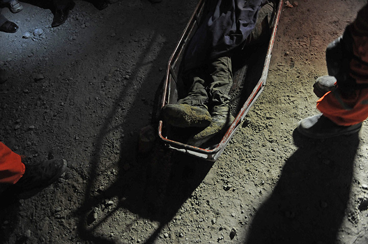 24 hours in pictures: A Firefighter stand over a victim of the earthquake in San Marcos
