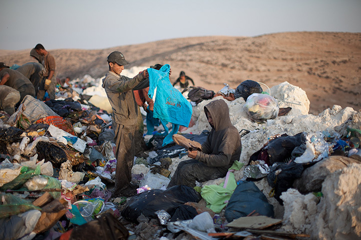 24 hours in pictures: Palestinian children scavenge through a garbage dump