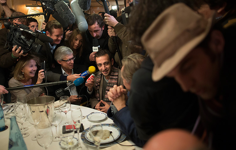 24 hours in pictures: French writer Jerome Ferrari is surrounded by media